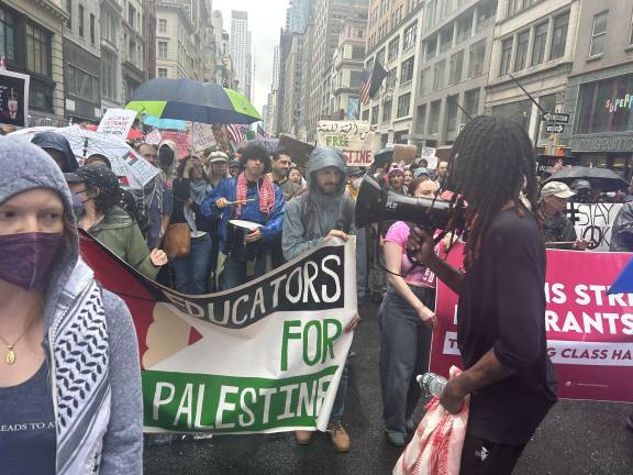 It rained heavily throughout the midday protest, which started at Bryant Park and took over Manhattan streets on June 14. An estimated 50,000 people marched in the “No Kings” demonstration.