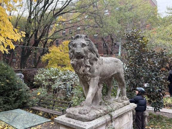 A youngster checks out one of the lion statues.
