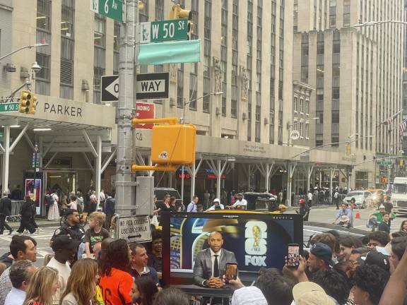 Thierry Henry (pictured above on the TV screen) made a special appearance through video at the street naming event. (Photo: Jacqueline Gordon)