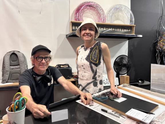 Curator Yohanna Magdalene Roa, right, and Whitebox founder Juan Puntes at Whitebox Portable inside the Times Square transit hub.