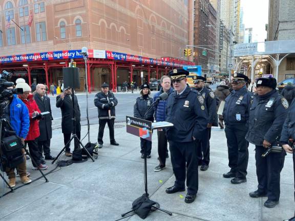 <b>As media and NYPD agents focus on Michael Pilecki, NYPD Transportation Bureau Deputy Chief, he summarizes the details of enhanced NYPD bus lane enforcement, in place since December 4th.</b> Photo: Ralph Spielman