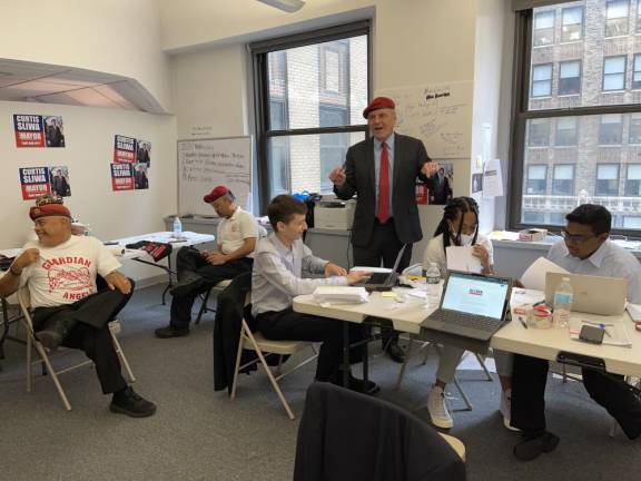 Republican mayoral candidate Curtis Sliwa confers with campaign staff. Photo by Arlene Kayatt.