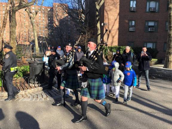 <b>Bagpipers from the NYC Sanitation Dept’s Emerald Society proudly led the parade past the fountain in the center of Stuyvesant Town on April 2.</b> Photo: Keith J. Kelly