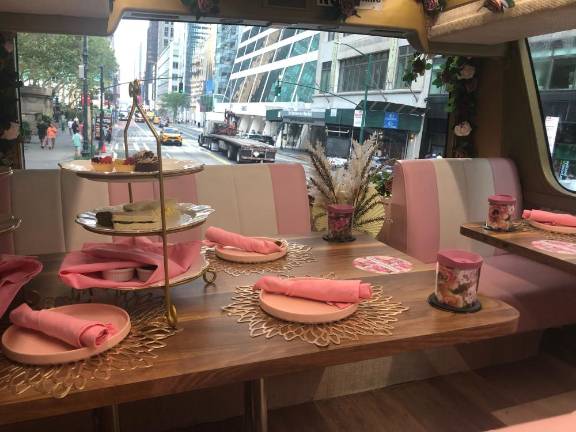 An elegant table setting on the Tea Around Town tour bus, where waiters can skillfully pour tea although they also make sure the cups have tops for when the bus hits the occasional pot hole on its journey around Manhattan. Photo: Lorraine Duffy Merkl