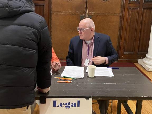 Rev. Paul Fleck, executive director of NY-JON, who is also an attorney, helps newcomers figure out their legal rights. Photo: Stephan Russo