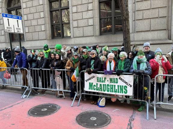 The woman in the white scarf said her mother came from Donegal and settled in Brooklyn in 1927. The extended family has been coming every year gathering behind a banner proclaiming them as the “Half-Mad McLaughlins.”
