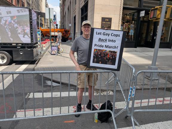 Protester with sign “Let Gay Cops Back into Pride March.”