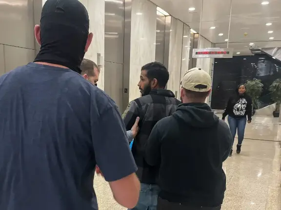 Federal agents detain a person after they finished an immigration hearing at 26 Federal Plaza in Manhattan, May 28.