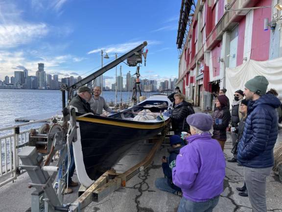 Members of Village Community boathouse say a bittersweet goodbye to the Whitehall Gig they built and rowed. Photo: Lorne Swarthart