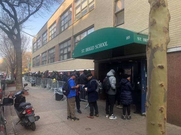 Over 160,000 migrants have descended on New York. Lines at the city’s sole relocation center for single adult migrants is in the East Village at the former St. Brigid School where lines frequently stretch for blocks. Adams said 99 percent of asylum seeks have found shelter. but warns city is at breaking point. Photo: Keith J. Kelly
