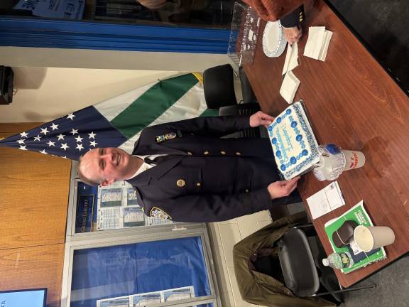 Neil Zuber, the 19th Precinct commanding officer, shows off a cake from a community council celebrating his promotion from deputy inspector to inspector in February. He is heading to the citywide Strategic Response Group as a special projects director. Among other things, the unit is charged with coordinating coverage around peaceful as well as violent protests.