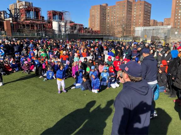 <b>The president of the Peter Stuyvesant Little League Seth Coren (at mic) tells youngsters, parents, coaches and area politicians after the opening day parade through Stuyvesant Town that there are 550 players enrolled in the league’s baseball, softball and challenger divisions this year</b>. Photo: Keith J. Kelly