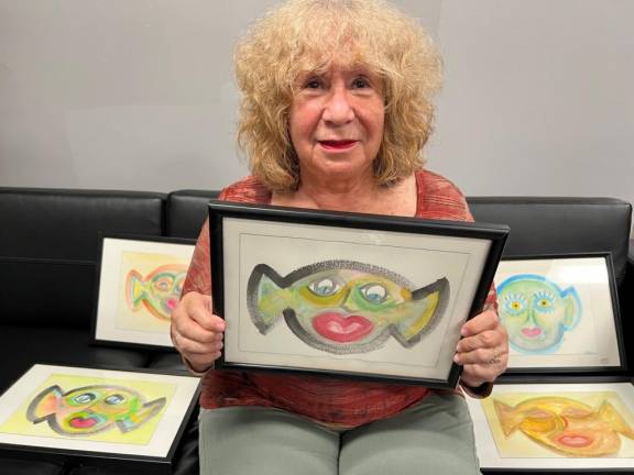 Eileen Millan with some of her “Mr. Big Ears” paintings. Photo: Robin Glasser Sacknoff