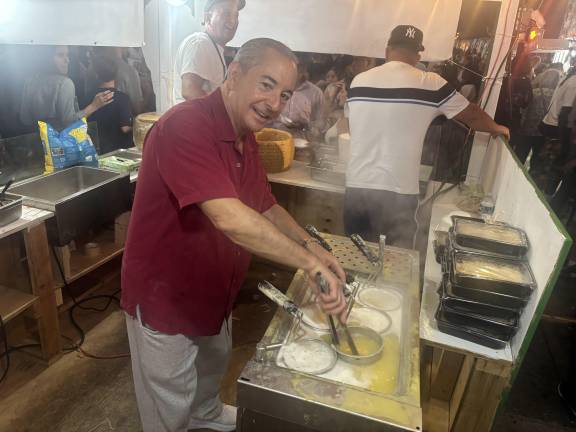 John DeLutro, also known as Baby John and the Cannoli King, keeps busy at a takeaway pasta booth during San Gennaro Festival 2025. He is the owner of Caffé Palermo and Baby John’s Pizza.