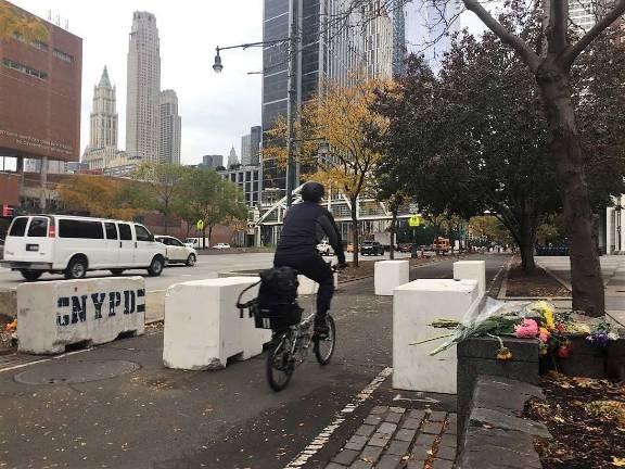 A cyclist passes newly installed concrete barriers on the Hudson River Park Bikeway in Lower Manhattan, near the site of the Oct. 31 vehicle attack that killed eight people. Photo: Michael Garofalo