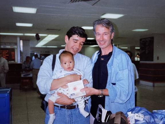 Ben with his dads after adoption from China. Photo courtesy of Ben Smith