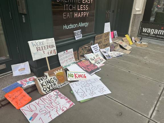 Protestors deposited their handmade signs on the sidewalk as the protest concluded.