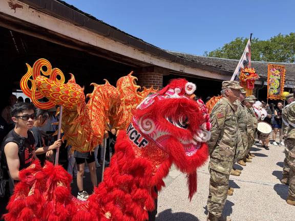 Lion dancers and veterans at during the flag raising ceremony at Castle Clinton.