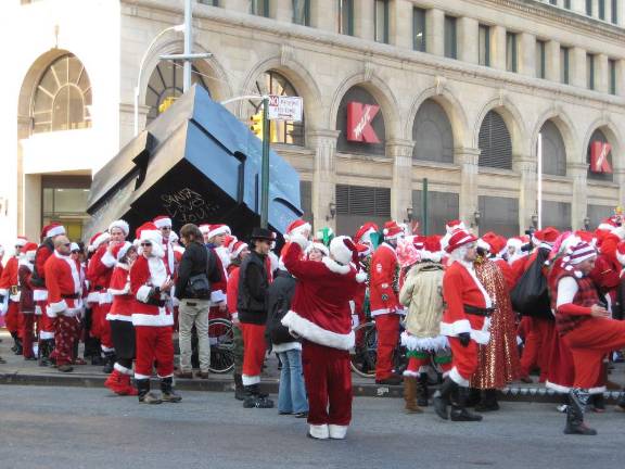 Santas convening around the Astor Place Cube during 2007’s SantaCon. They scribbled pronouncements such as “Santa Loves You!!” on the side of the famous spinning monument.