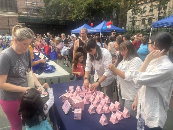 There was brisk business at the table of the Swedish candy company Bon Bon, staffed by (from left) Alexis Metha, Jamie Kern, and Katrina Tang, who were busy passing out samples in tiny pink bags.