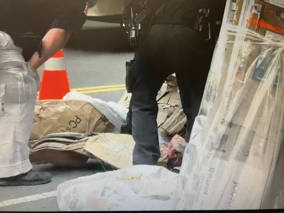 Police gather around improperly discarded medical waste initially mistaken for a child’s foot and blood.