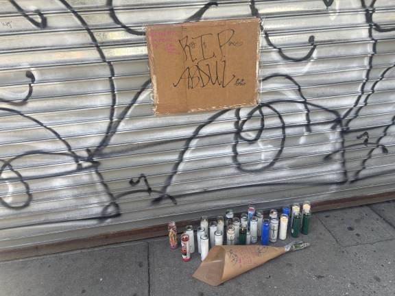 There were candles, flowers and a handwritten sign at a growing, makeshift memorial outside Sal’s Deli and Grocery were Abdul Saleh worked. He was killed after a scuffle with another man on the night of April 25.