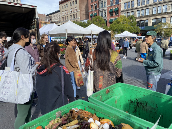 A representative from the Lower East Side Ecology Center talks about composting to a group at the Union Square Greenmarket. Photo: LES Ecology Center