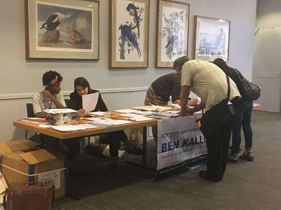Citizens sign in for a town hall meeting last week.