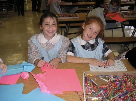 Dylan (right) and the author (left) coloring in a cafeteria before one of their school shows. Photo courtesy of Gaby Messino