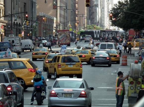 Traffic on Eighth Ave. The MTA predicts traffic below 60th St. will be reduced by 20 percent once congestion pricing begins next spring. But there is a lot of behind the scenes wrangling over exemptions now underway. Photo: Erik Drost/Wikimedia Commons