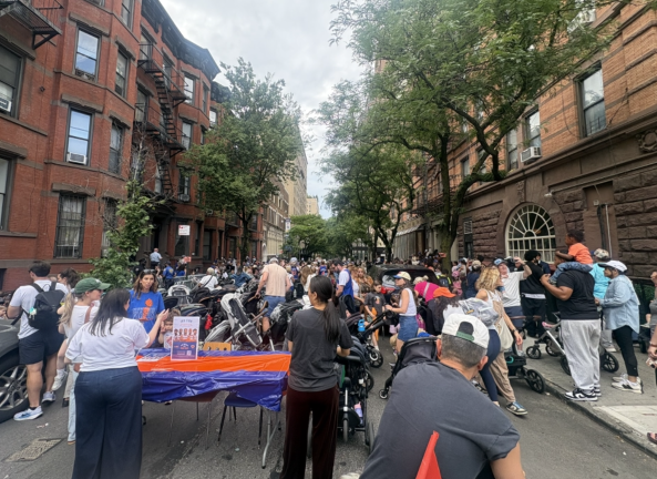 Children, parents, and caregivers gather outside the Children’s Museum of Manhattan to celebrate the Knicks win with music, crafts, and other activities.
