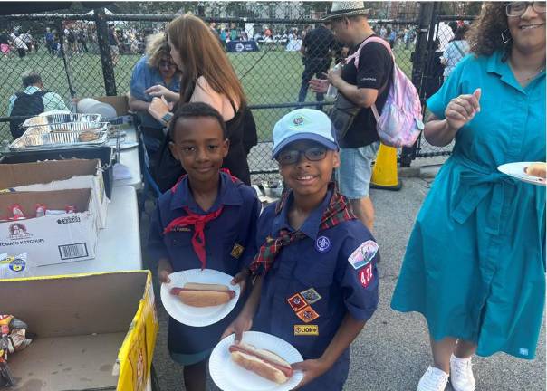 Families got their hot dogs National Night Out Against Crime at a grill manned by officers from the 13th Pct.