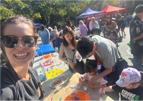 Lindsey Peers, owner of the Craft Store, had her three children helping youngsters make refrigerator magnets with the slogan “I ♡ NYPD.”
