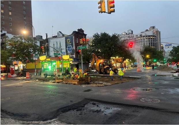 City workers were still laboring into the evening on Aug. 7 trying to repair the roadway at the intersection of East 14th Street and First Avenue.
