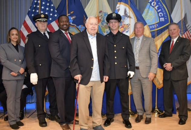Port Authority Police Department recruit Sean Krueger (third from right) received the shield worn by his grandfather, retired Sergeant Conrad Krueger (standing with cane) during the badge ceremony.
