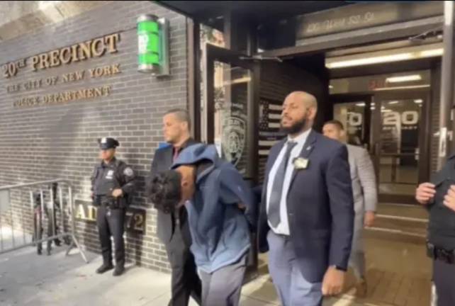 Gunman Eduardo Diaz keeps head down as he’s perp-walked from 20th Precinct on Nov. 8, 2024.