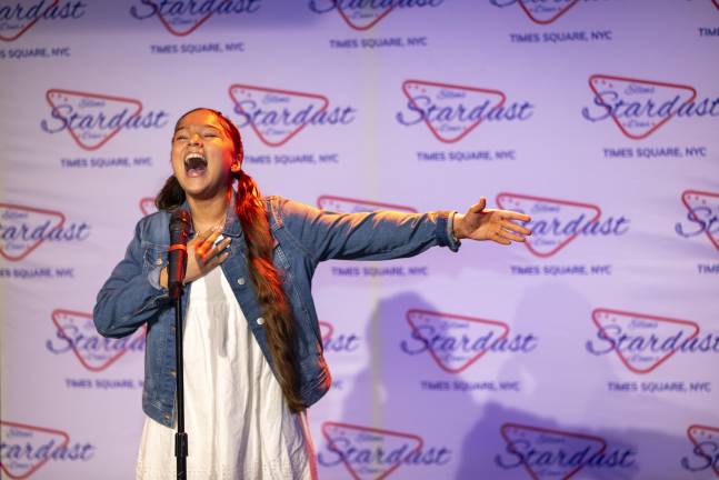 Charlotte Van Ledtje singing “Tomorrow” from “Annie.” Hart announced Charlotte’s award, the Esprit de Corps Award, saying, “Charlotte with the winning smile,” joking that her smile is like Doris Day’s, whom Charlotte had not heard of, but soon saw pictures of online.