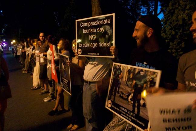 About 100 people attended the vigil on Central Park South. Photo: Mary Culpepper