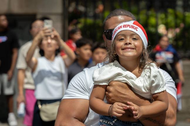 A man who rarely misses “arm day” with a smiling toddler girl.