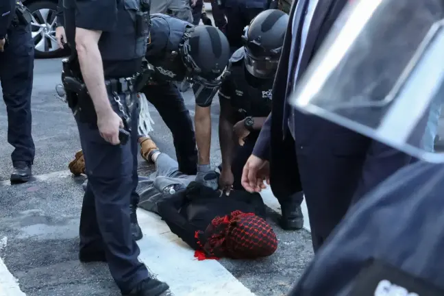NYPD officers arrest a protester outside the Federal Building in Lower Manhattan, June 10, 2025.