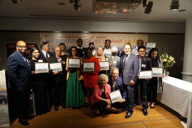 The 2023 Building Service Worker Award honorees. Kneeling in the front row are Straus News Publisher Jeanne Straus and 32BJ President Manny Pastreich, with Errol Louis of NY1 standing on the leftmost side.