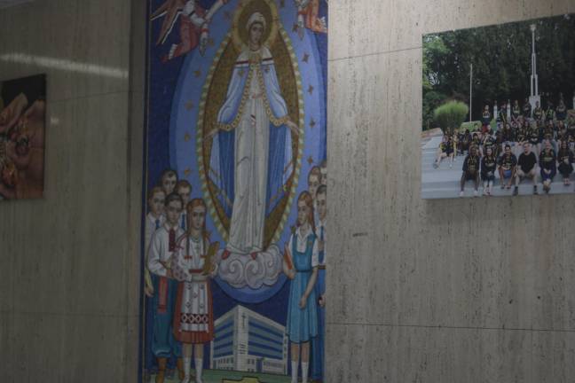 Catholic mosaics and photos of past classes decorate the walls of Saint George Academy.