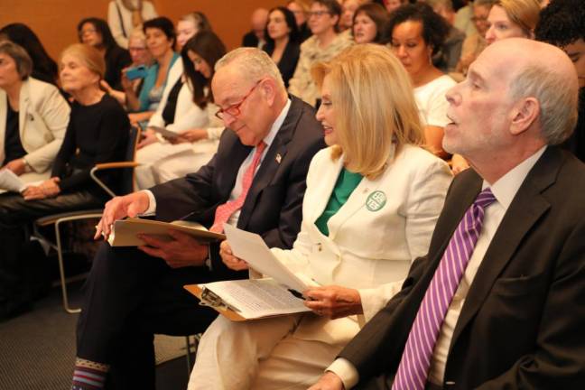 Senator Chuck Schumer (center) and former Congress member Carolyn Maloney review notes as they kick off a petition drive for the Equal Rights Amendment.