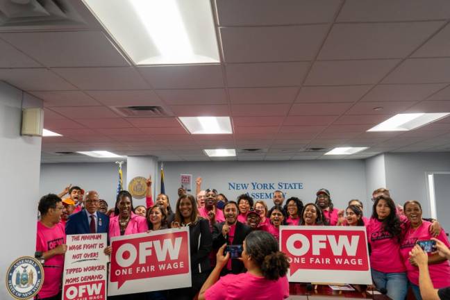 Elected officials, advocates, and members of One Fair Wage pose for a group picture at the end of the press conference. (Priyanka Rajput)