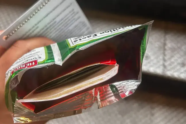 Former City Hall aide Winnie Greco handed THE CITY reporter Katie Honan a potato chip bag containing an envelope full of cash after a reelection event for Mayor Eric Adams in Harlem, Aug. 20, 2025.