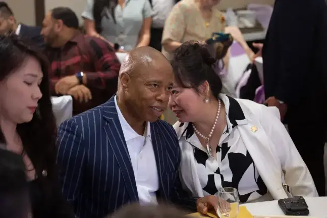 Winnie Greco, at the time a City Hall Asian Affairs adviser, speaks with Mayor Eric Adams at a community event in Flushing, May 31, 2023.