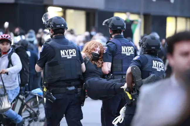 A marcher is carried away by police officers at an anti-ICE protest in Lower Manhattan, June 10, 2025.