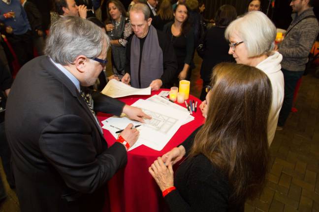 Illustrator John S. Winkleman signing copies of his drawings.