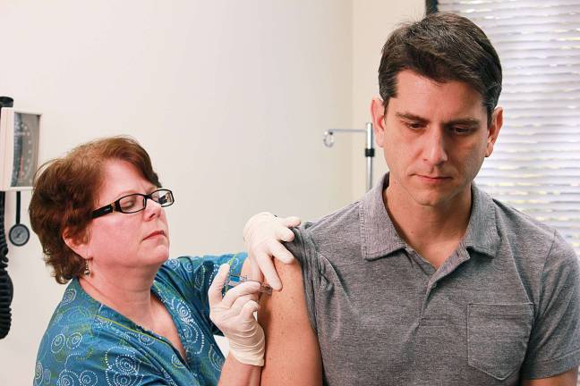 A nurse administers a flu vaccine. Photo: CDC/Douglas Jordan, M.A.