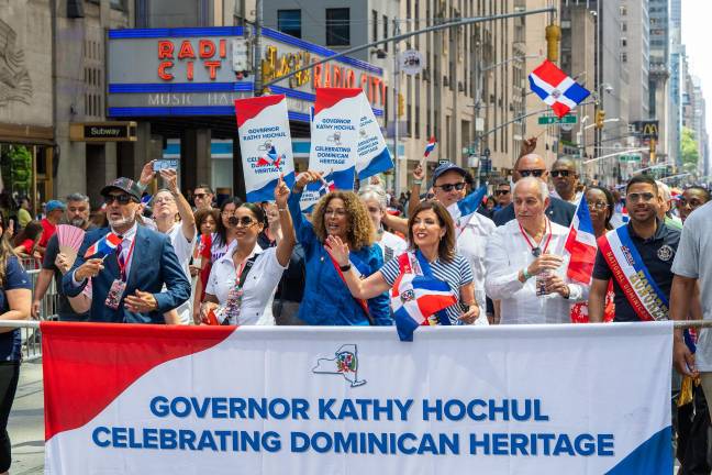 Governor Hochul (in striped dress) on the march.